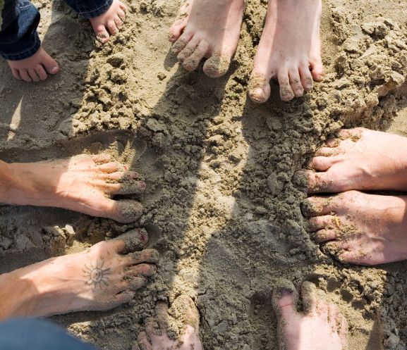 Feet in sand forming a circle