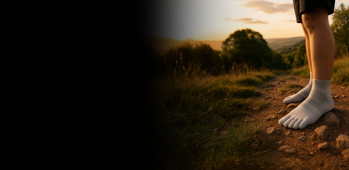 Feet in grey toe socks on a dirt trail at sunset